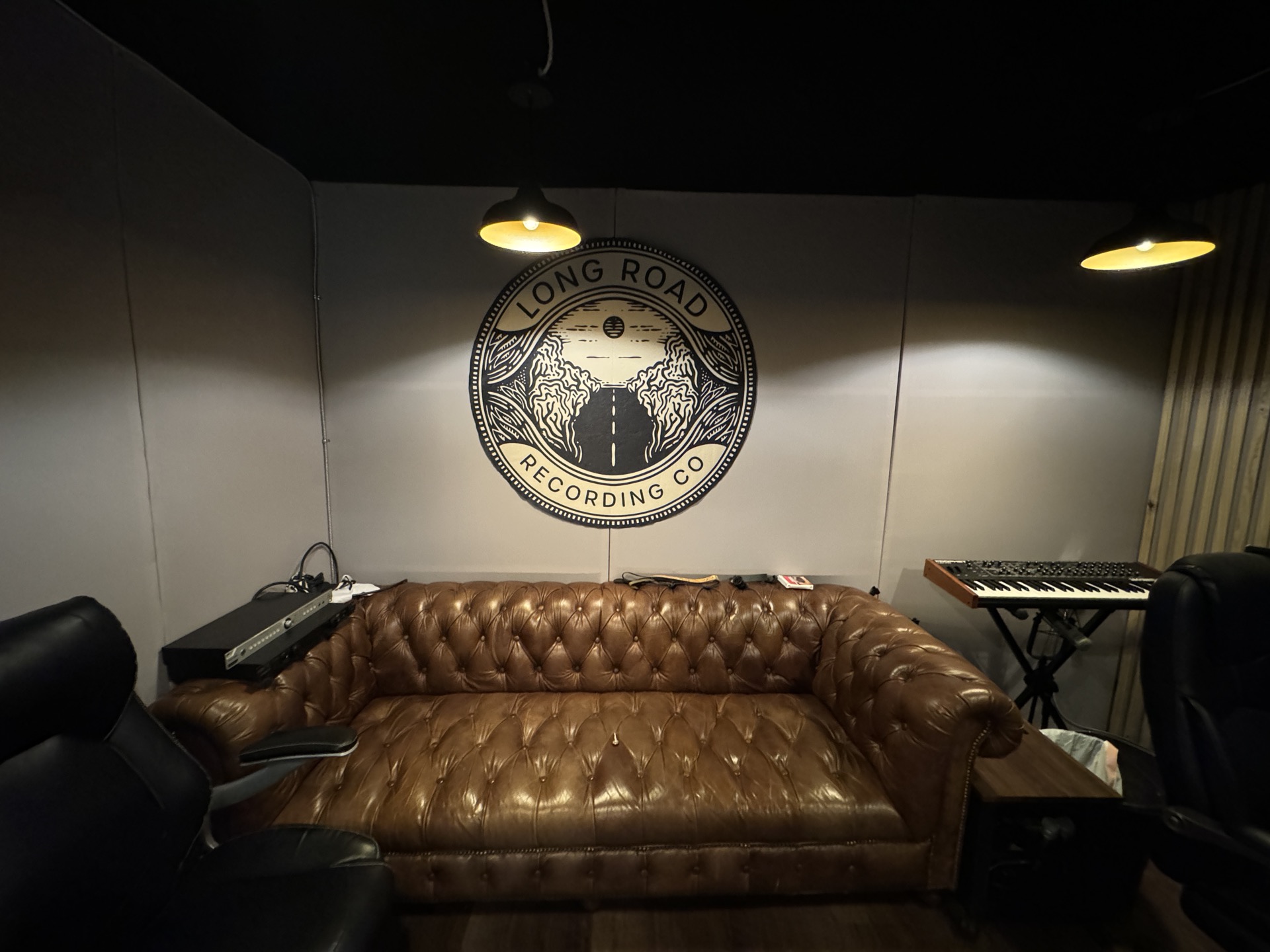 Long Road Recording lounge area with leather couch and studio logo